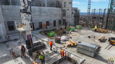 Dynamic view of high-rise construction site from a tower crane