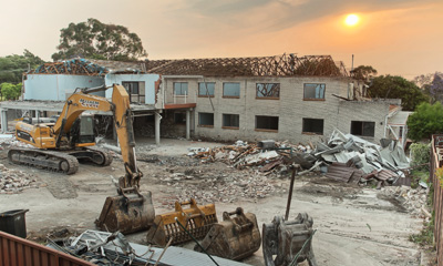 Large House being demolished captured via industrial cinematography.
