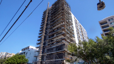 High-rise construction site surrounded by scaffolding