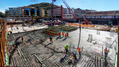 Detailed view of construction workers managing a concrete pour on site.